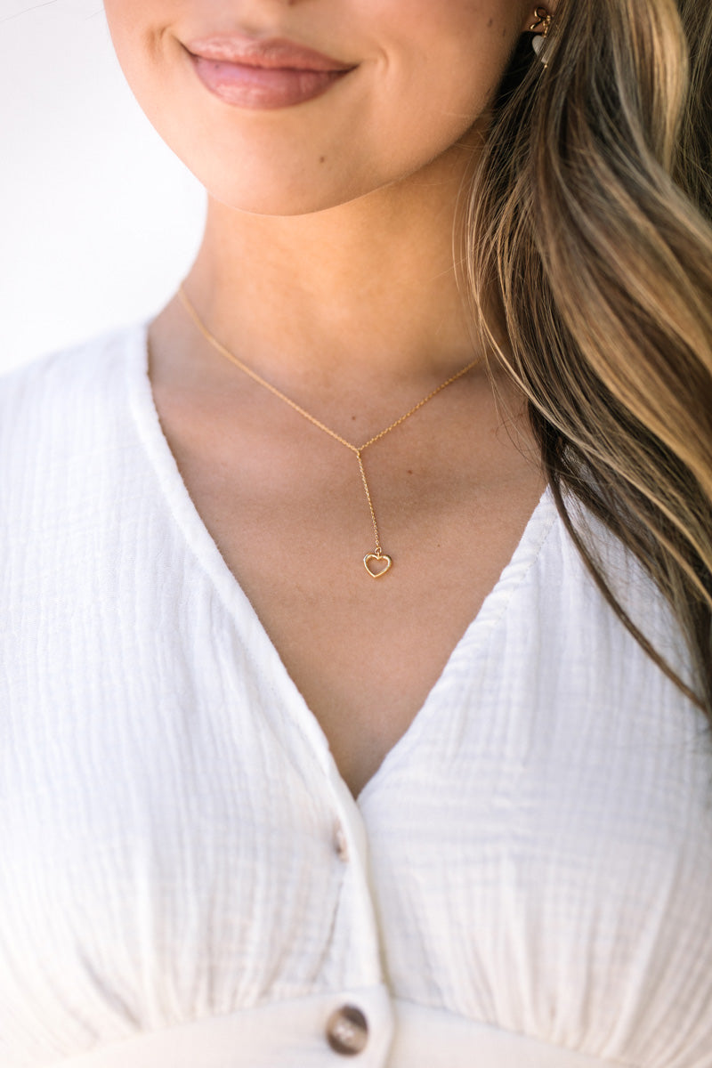 A simple yet elegant gold-toned heart pendant necklace with a delicate chain, showcasing a minimalist and feminine design.