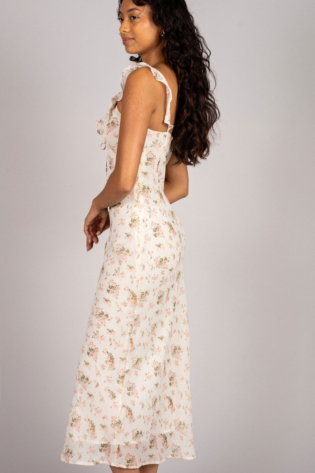 A floral chiffon dress in a light, airy pattern featuring a tiered bodice and adjustable straps.