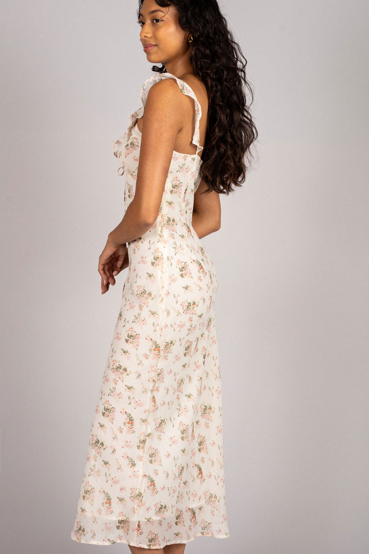 A floral chiffon dress in a light, airy pattern featuring a tiered bodice and adjustable straps.