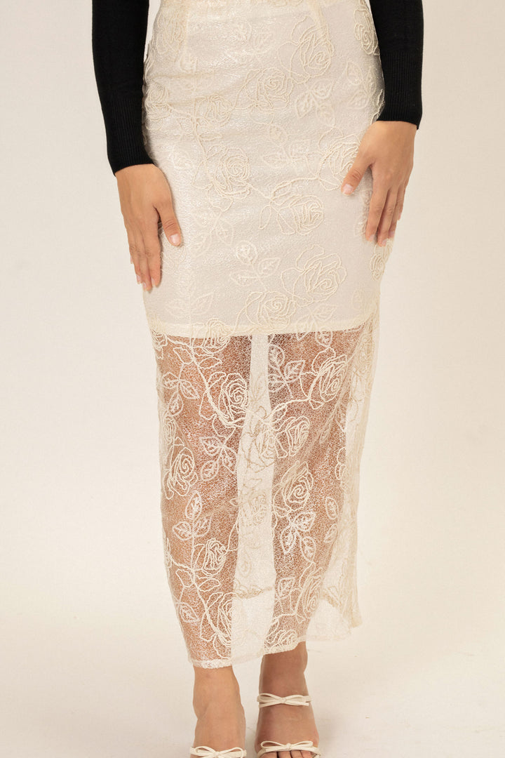 A white lace skirt with intricate floral patterns, featuring a fitted silhouette and midi length.