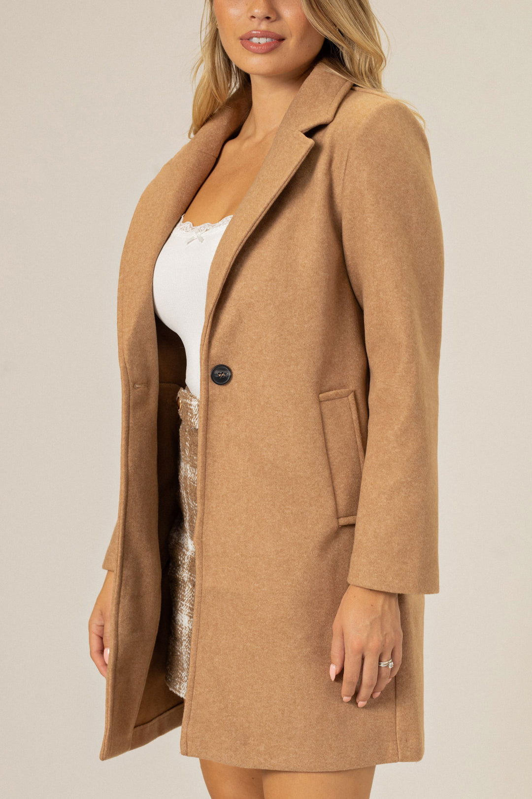 A tan wool-blend coat with notched lapel, single-breasted design, and two front pockets.