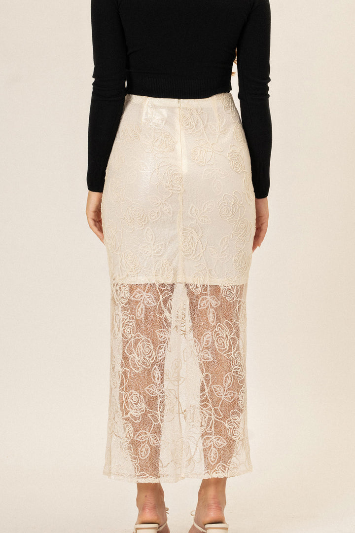 A white lace skirt with an elegant floral pattern, featuring a high waist and a midi length.
