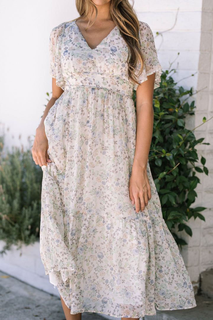 A lightweight, flowing floral print dress with flutter sleeves and a tiered skirt.