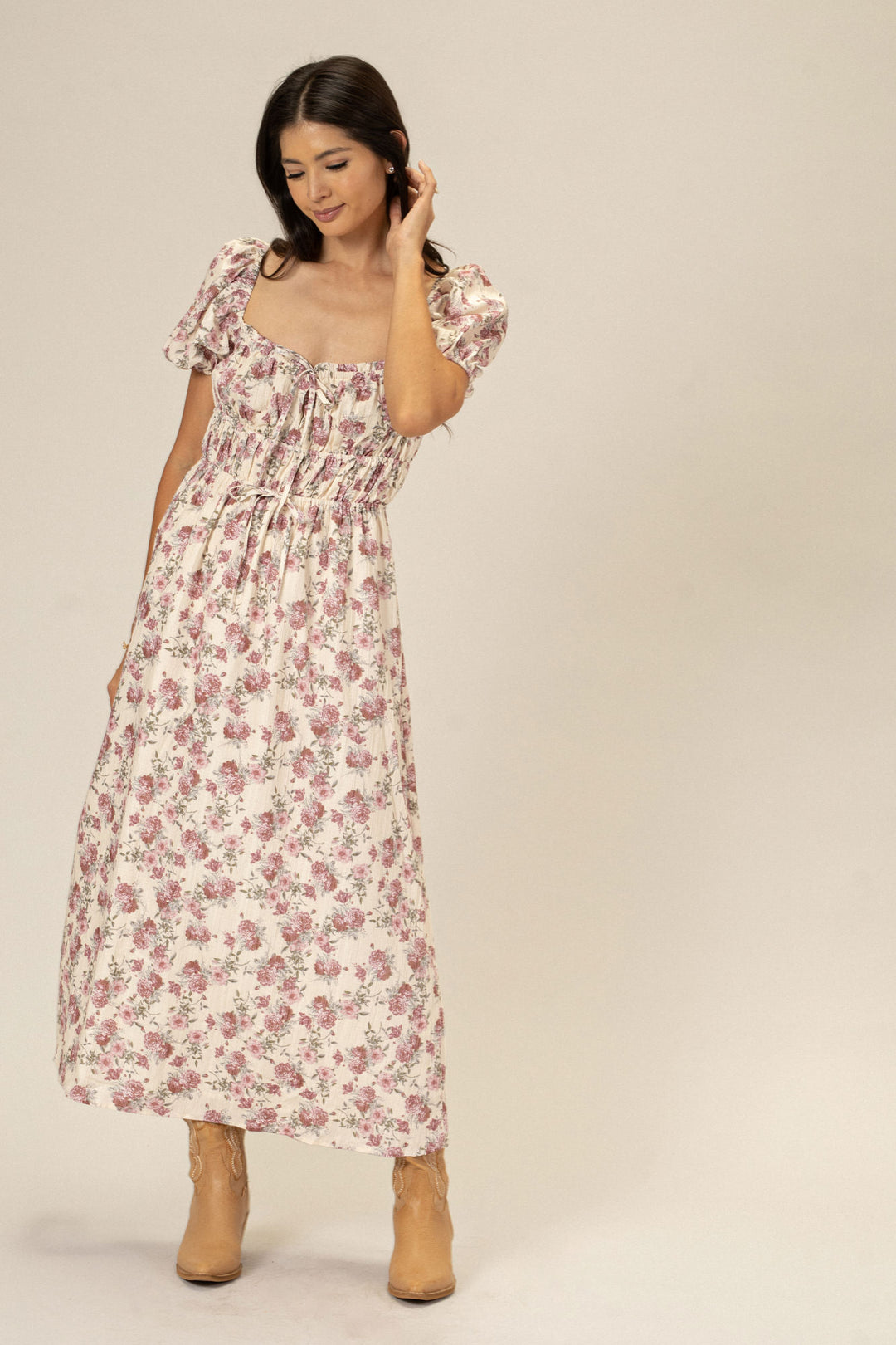 A floral print dress with puff sleeves and a high-low hem, perfect for a romantic, feminine look.