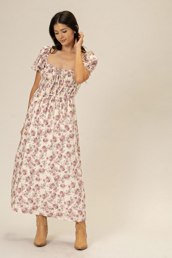 A floral print dress with puff sleeves and a high-low hem, perfect for a romantic, feminine look.