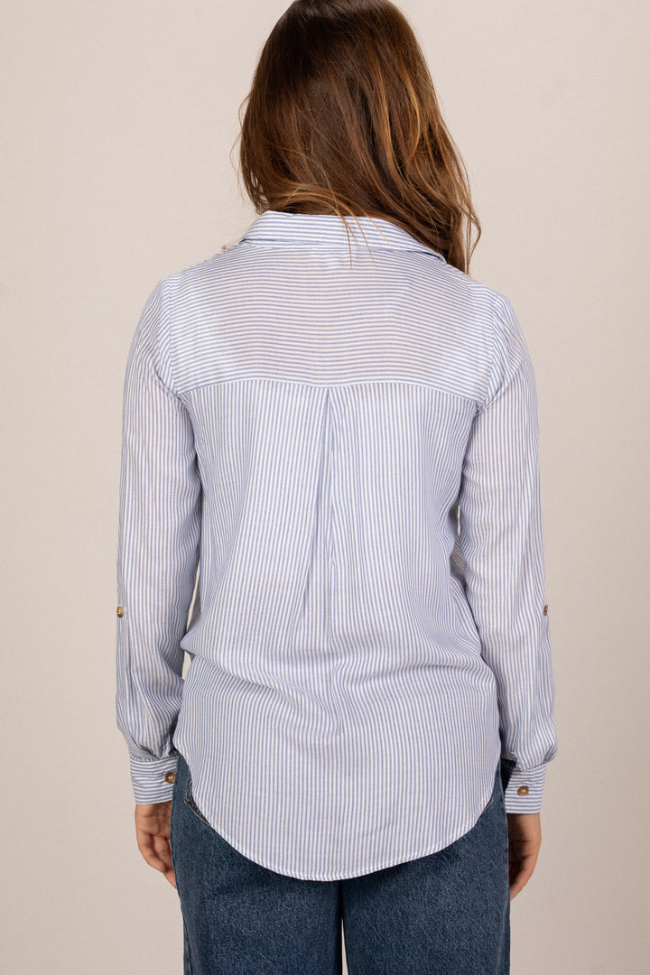 A blue and white striped button-up shirt with long sleeves and a collared neckline, featuring a fitted silhouette and a pleat detail on the back.