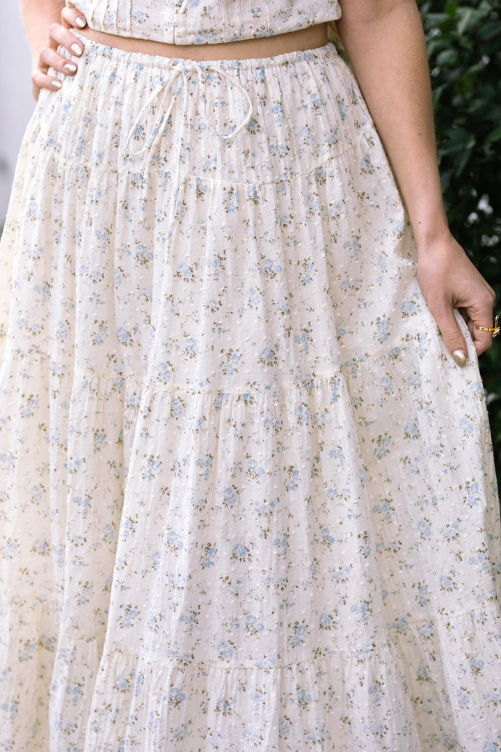 A floral-printed, lightweight skirt with a tiered, ruffled silhouette and a drawstring waist, providing a feminine, breezy look.