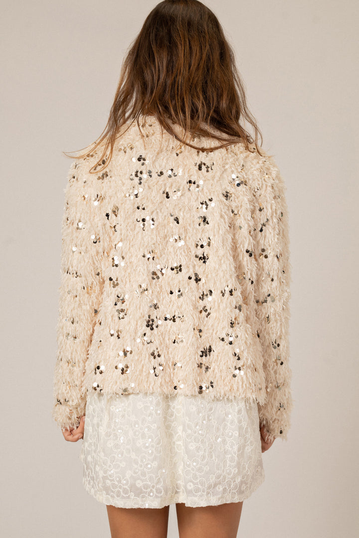 Soft, shaggy feather and sequin-embellished cream cardigan with long sleeves and open front.