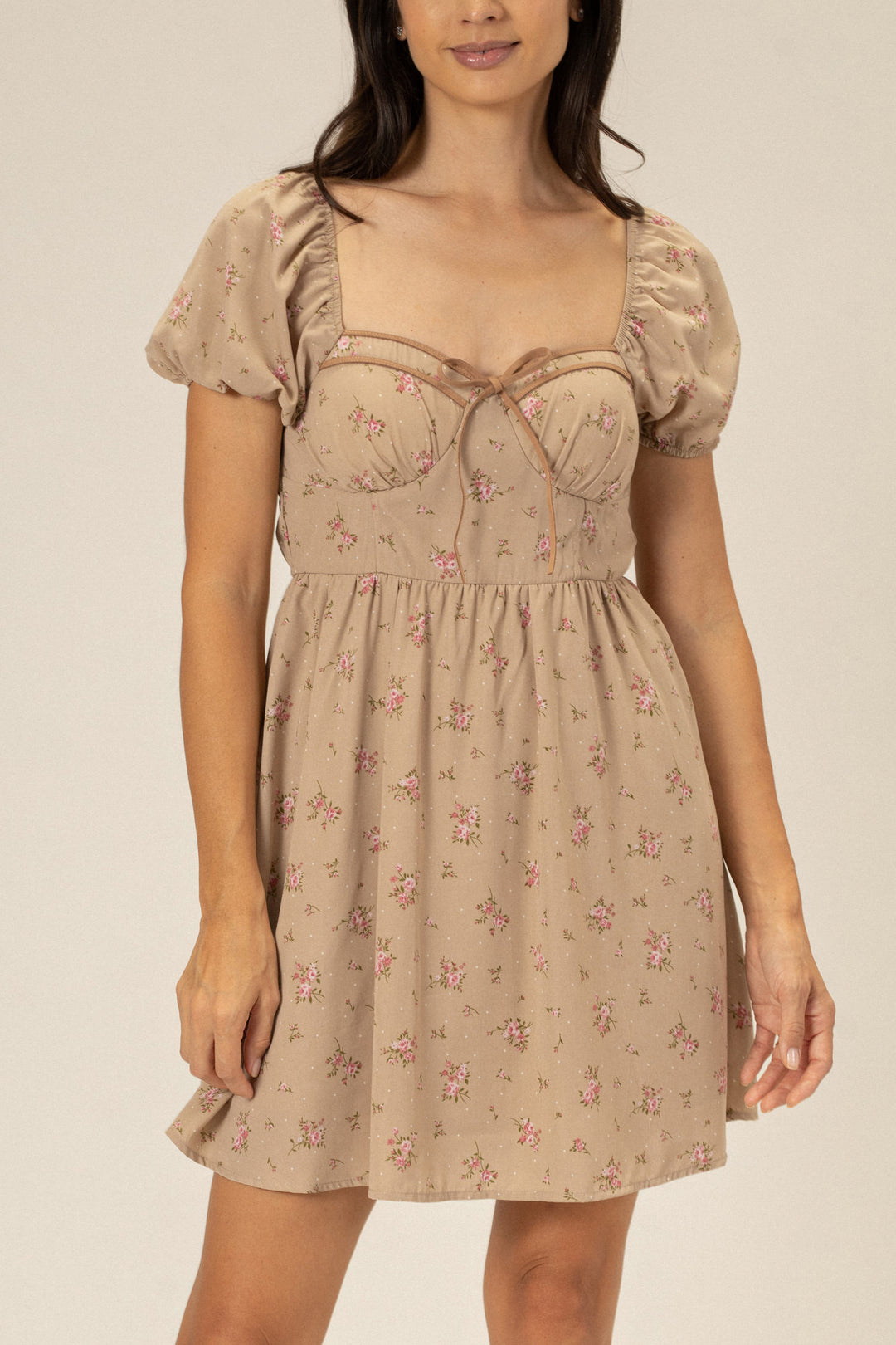 Beige mini dress with floral print, puff sleeves, and sweetheart neckline.
