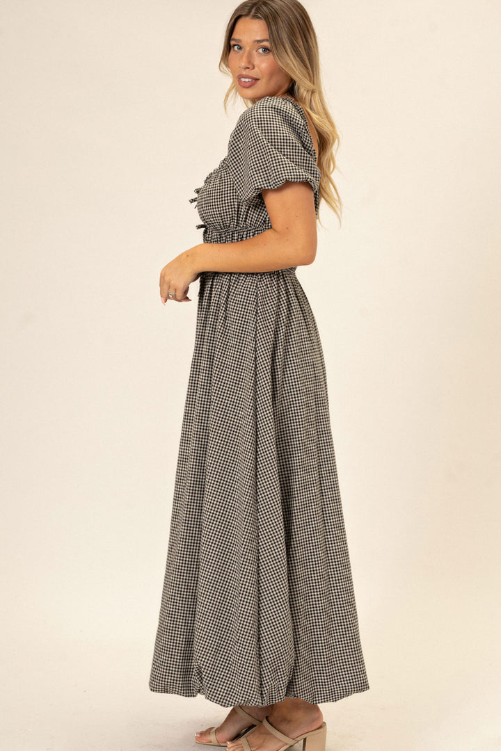 A gingham-patterned dress with a flared, bubble-hem skirt and short puff sleeves, creating a feminine, retro-inspired look.