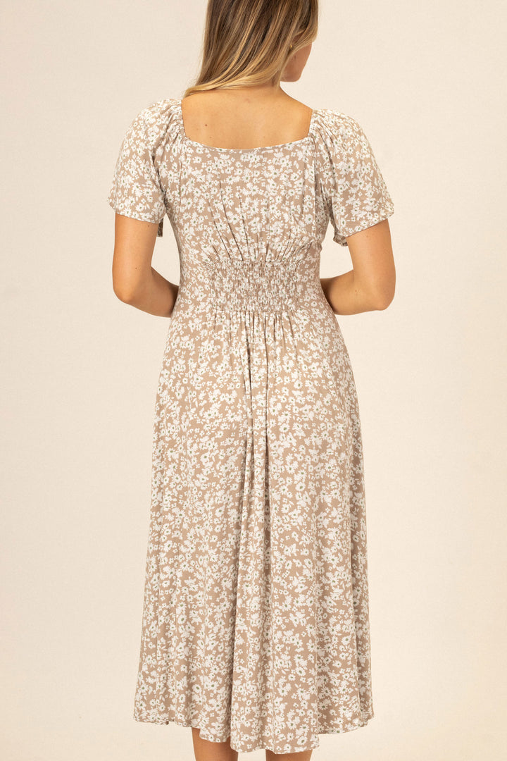 Floral patterned midi dress with short puff sleeves, smocked waistline, and scoop neckline.