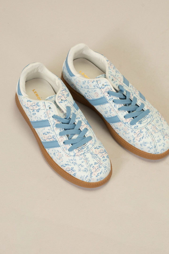 Light blue and white floral patterned sneakers with lace-up closure and gum sole.