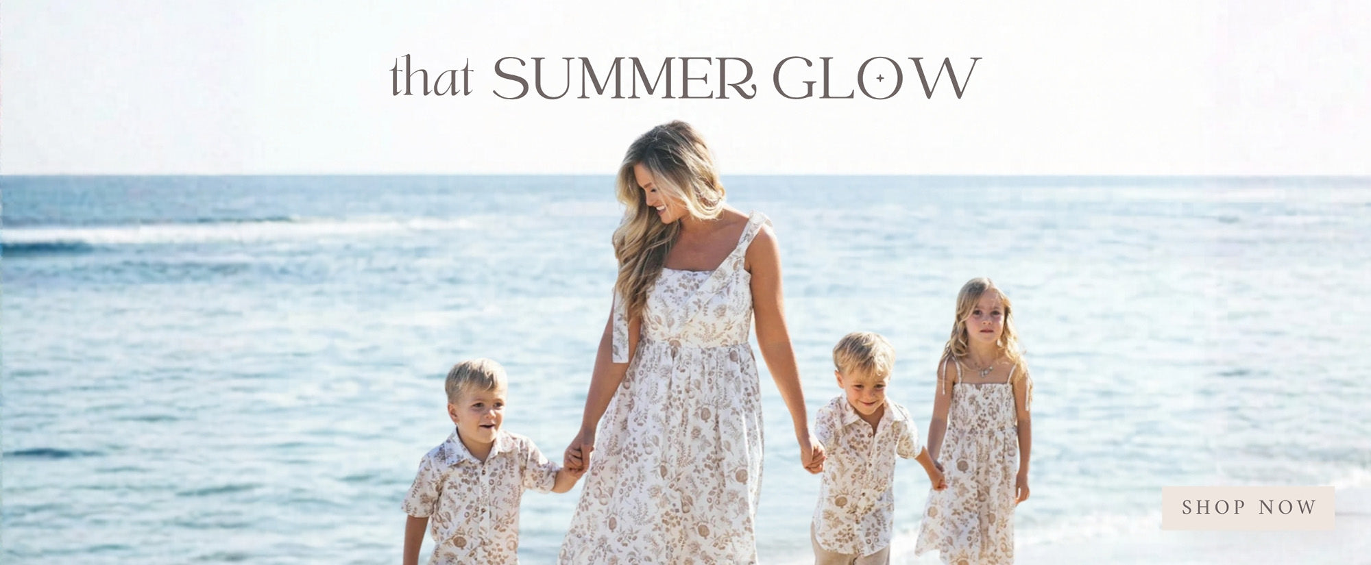 Woman and two children on a beach with text 'that SUMMER GLOW' and 'SHOP NOW' button.