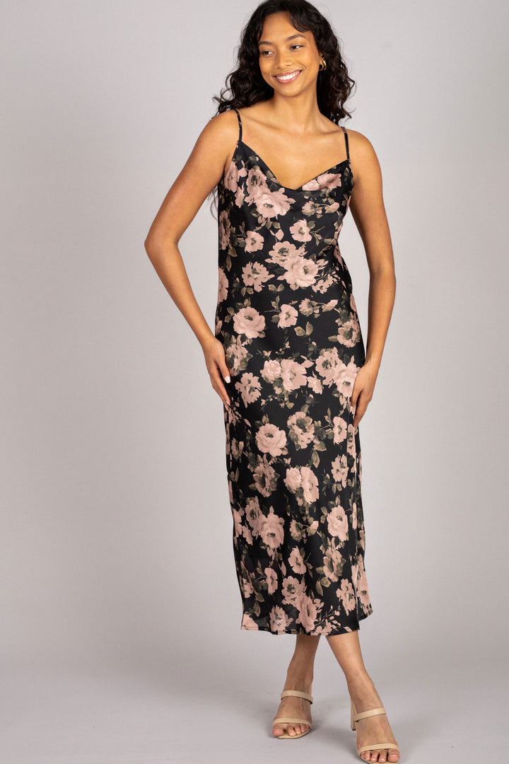 A black floral print midi dress with spaghetti straps, featuring a flattering v-neckline and figure-skimming silhouette.