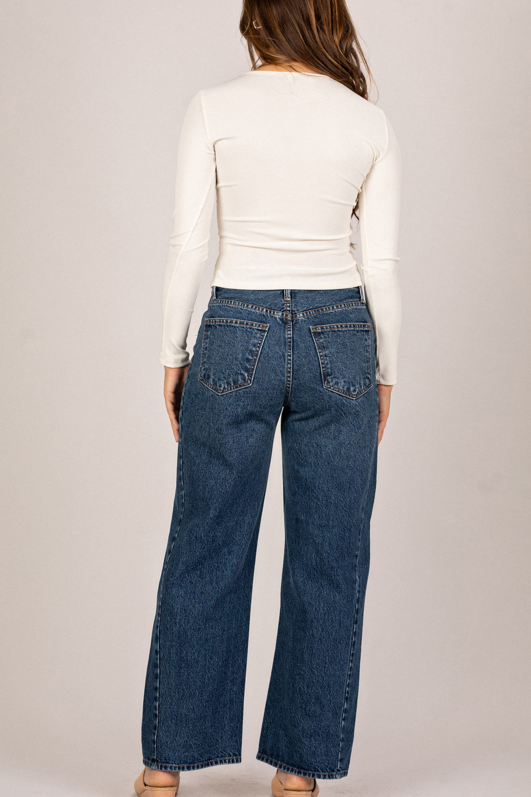 High-waisted dark denim barrel jeans with classic 5-pocket design and wide, relaxed leg silhouette.