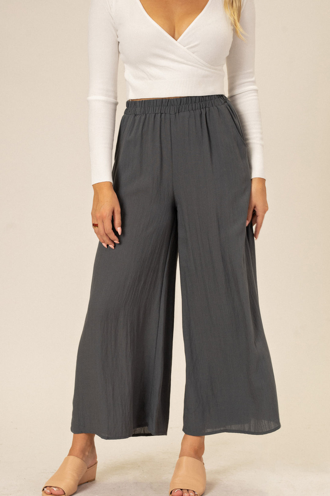 Gray wide-leg pants with an elastic waistband and relaxed, comfortable fit.