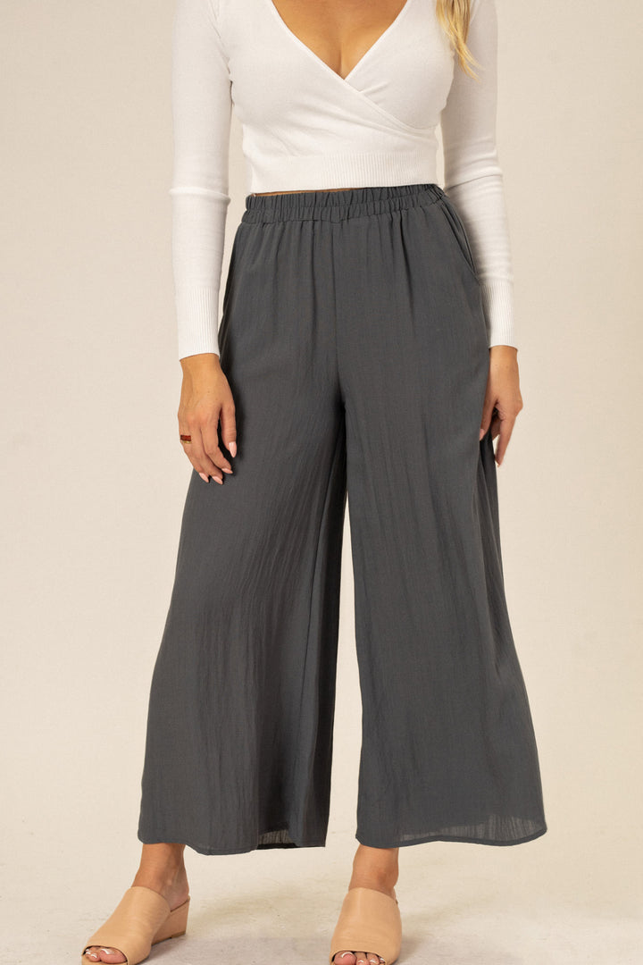 Gray wide-leg pants with an elastic waistband and relaxed, comfortable fit.
