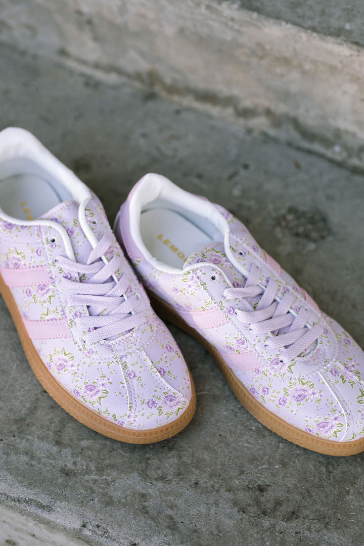 Lightweight, lilac-hued sneakers with a delicate floral pattern and gum sole, lace-up design for a comfortable fit.