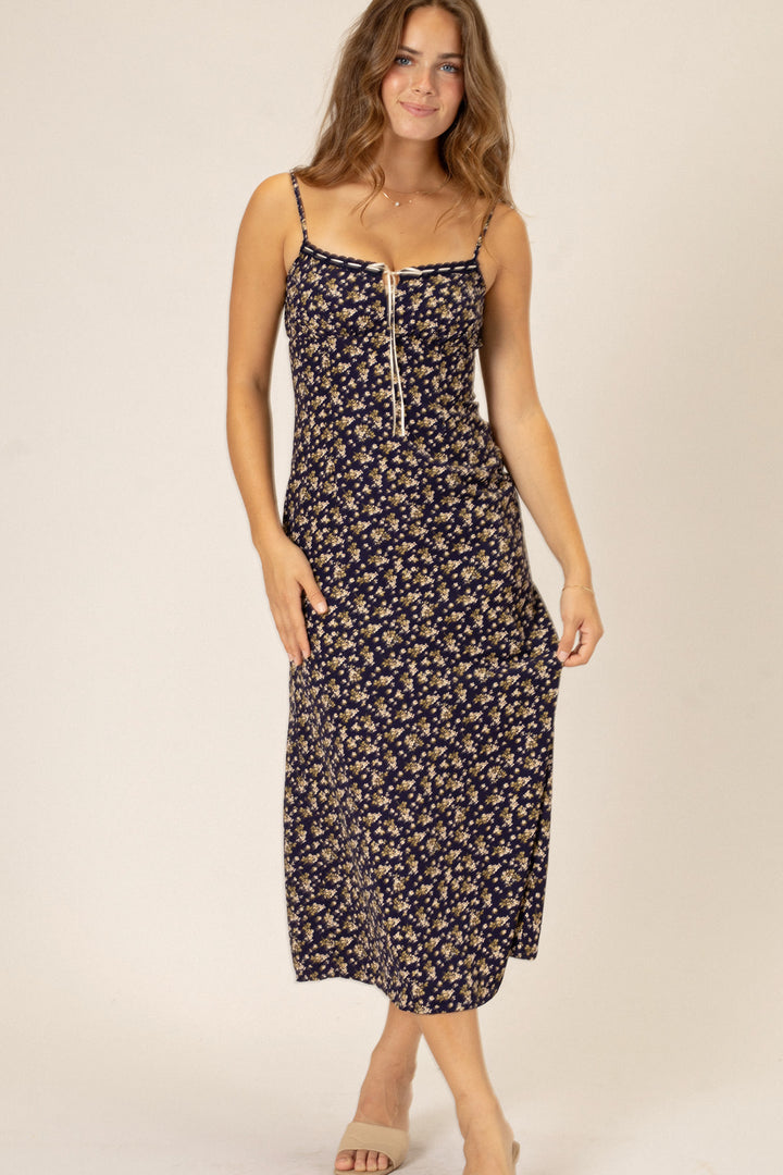 Sleek navy floral midi dress with spaghetti straps and button-up front closure for a stylish, feminine look.