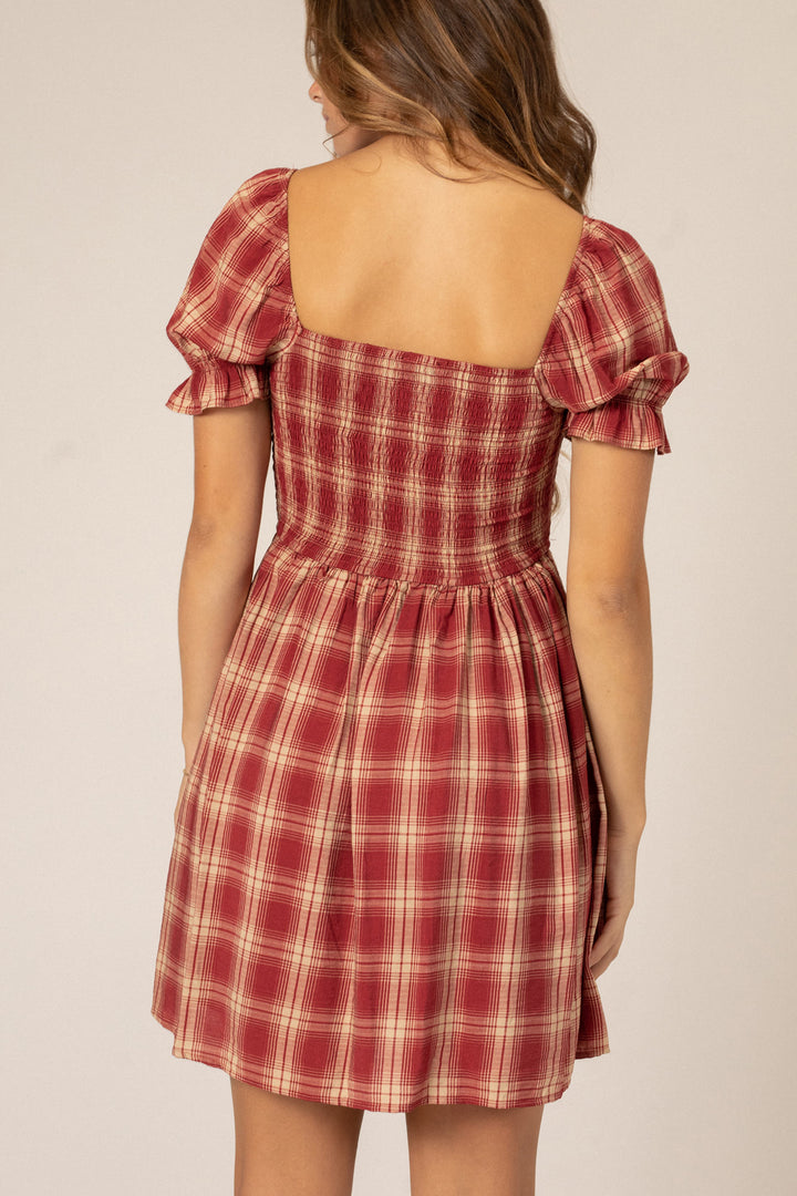 Vibrant red and white plaid mini dress with puff sleeves, square neckline, and smocked waist.