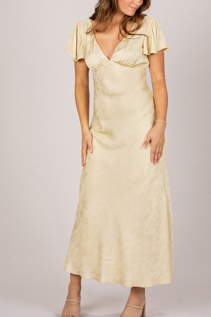 A beige midi dress with short flutter sleeves, a deep V-neck, and a fitted silhouette, showcasing an elegant, feminine style.