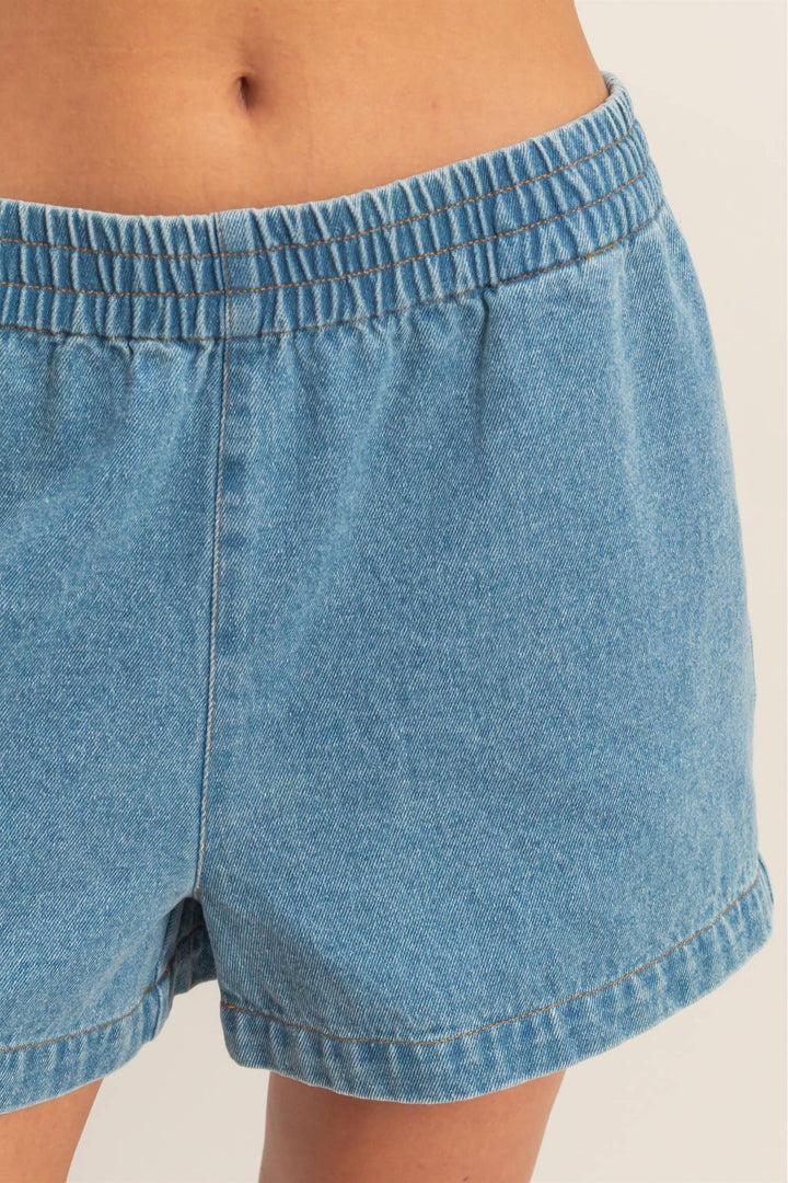 Light blue denim shorts with an elastic waistband and visible stitching details.
