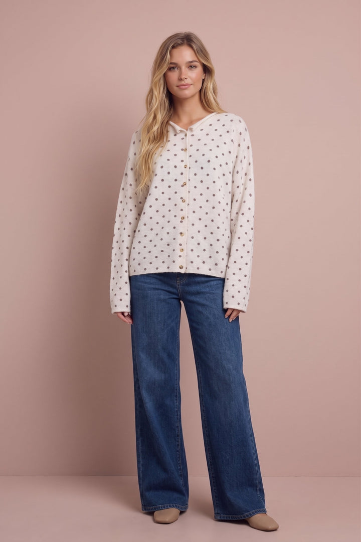 Ashley Polka Dot Knit Cardigan in cream with brown dots, paired with dark blue jeans, front view.