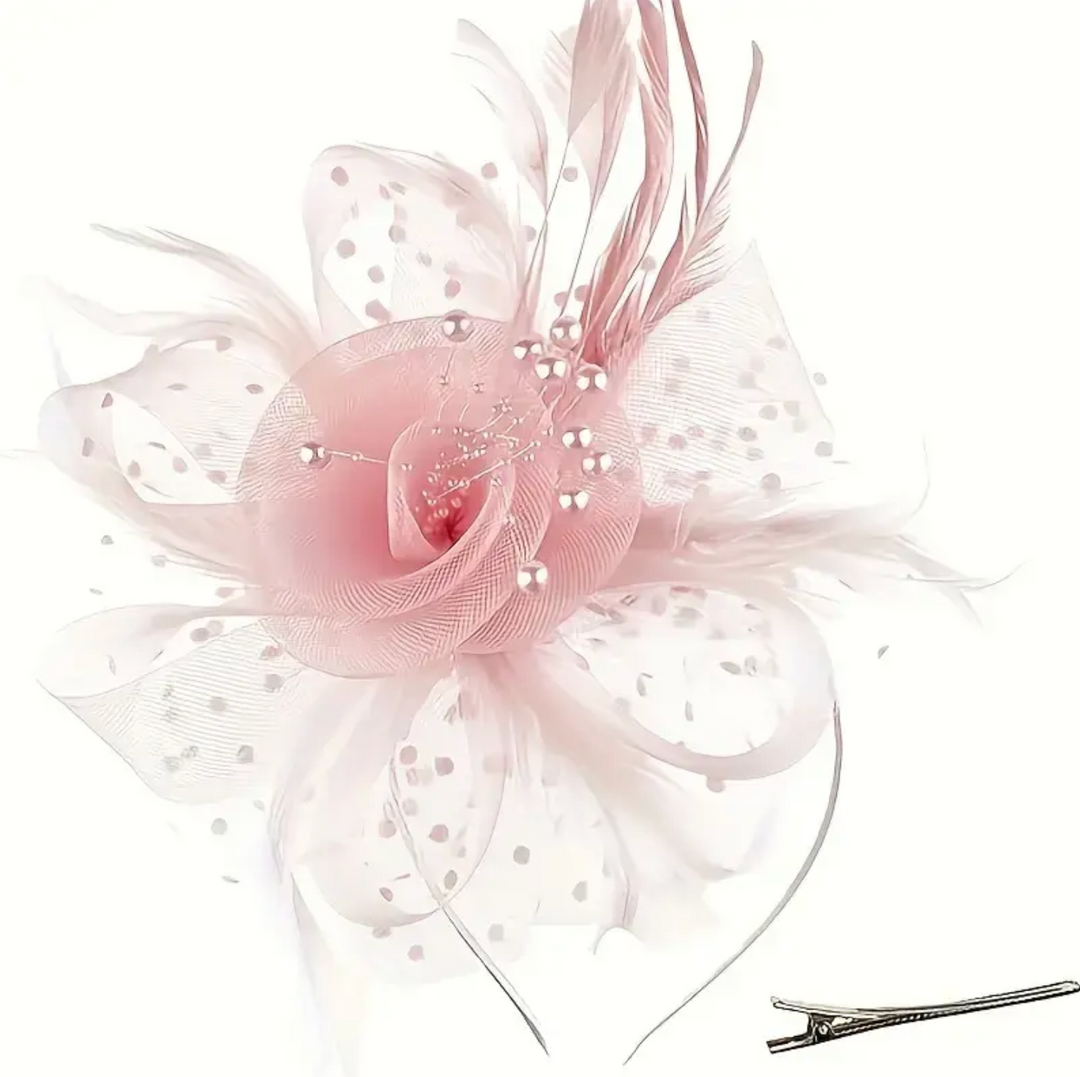 A pale pink fascinator hat with delicate feathers, polka dots, and a floral design, perfect for formal occasions.