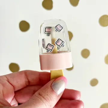 Small, pink popsicle-shaped lip gloss with colorful fruit-themed designs.