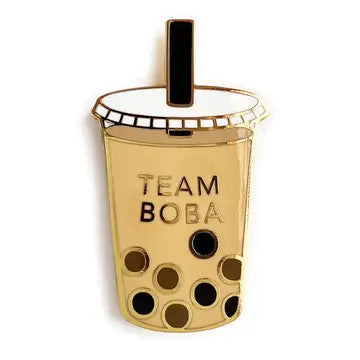 Gold-toned enamel pin featuring the text "TEAM BOBA" and a bubble tea-inspired design with black polka dots.