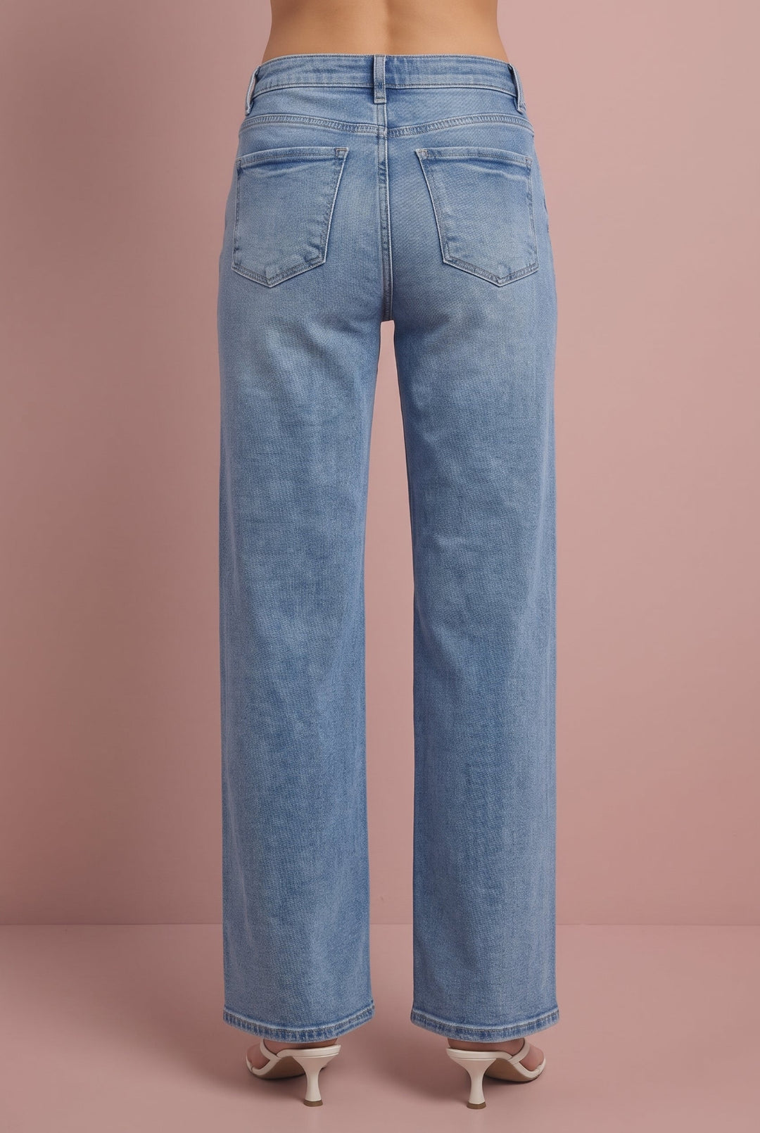 Light blue straight-leg jeans, back view, on pink background.