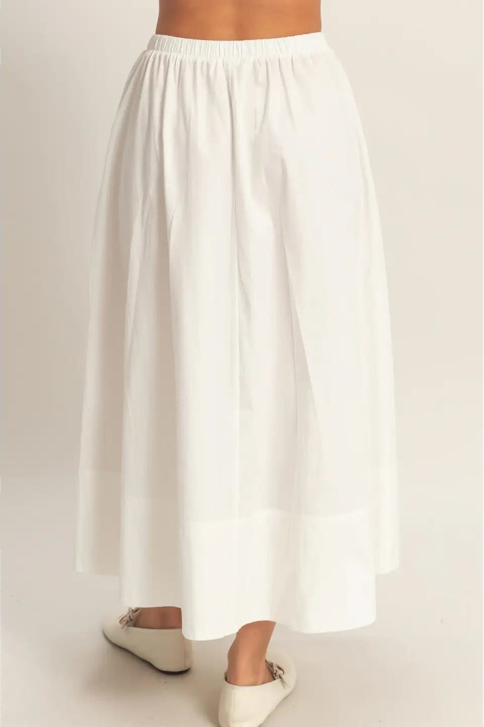 White wide-leg pants on a plain background