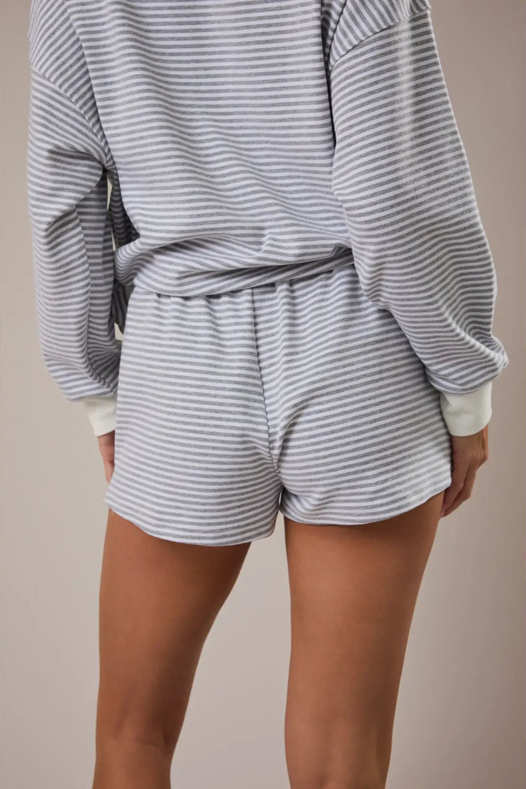 Gray and white striped mid-rise shorts with an elastic waistband and tapered legs.