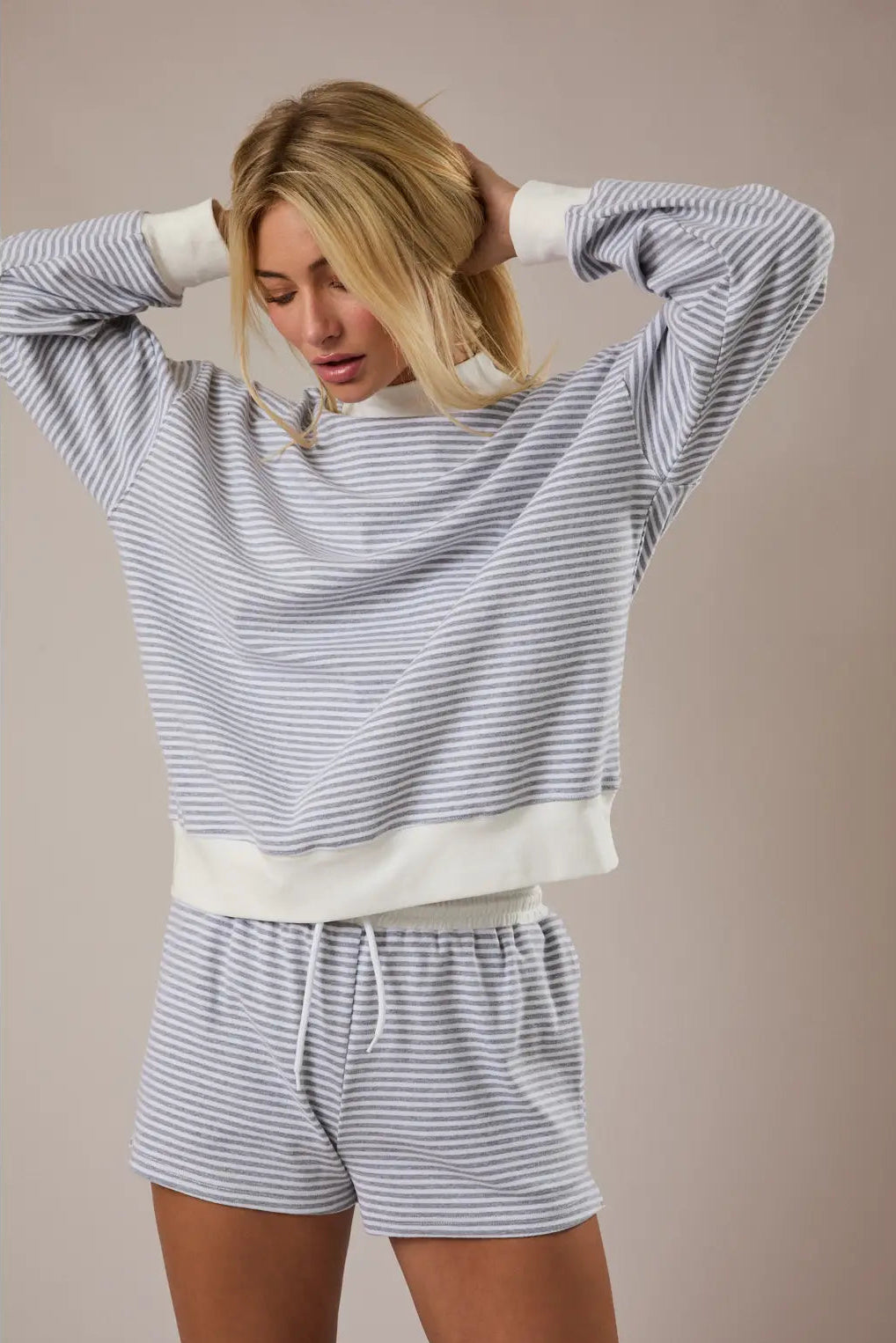 Striped mock neck sweatshirt with long sleeves, made of soft cotton-blend fabric in a light gray and white color scheme.