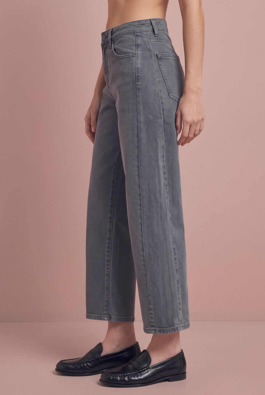 Gray wide-leg cropped jeans with high waist, shown from side view with black loafers.