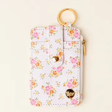 Floral-patterned keychain wallet with zippered compartments and a wooden ring attachment.