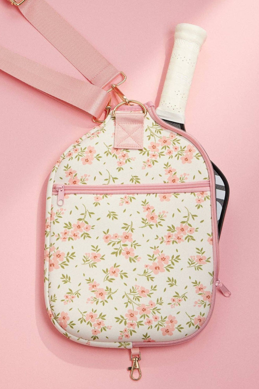 A lightweight, floral-patterned neoprene pickleball paddle bag with a pink zipper and strap, offering a stylish way to transport your pickleball essentials.