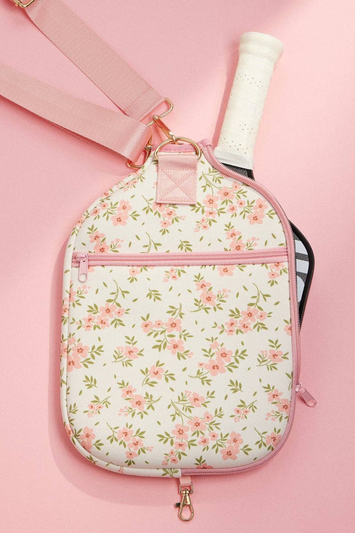 A lightweight, floral-patterned neoprene pickleball paddle bag with a pink zipper and strap, offering a stylish way to transport your pickleball essentials.