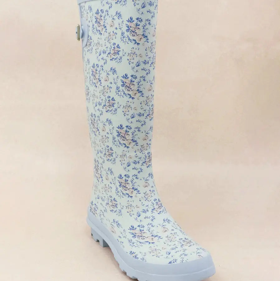 Blue floral patterned rain boots with textured sole for traction.