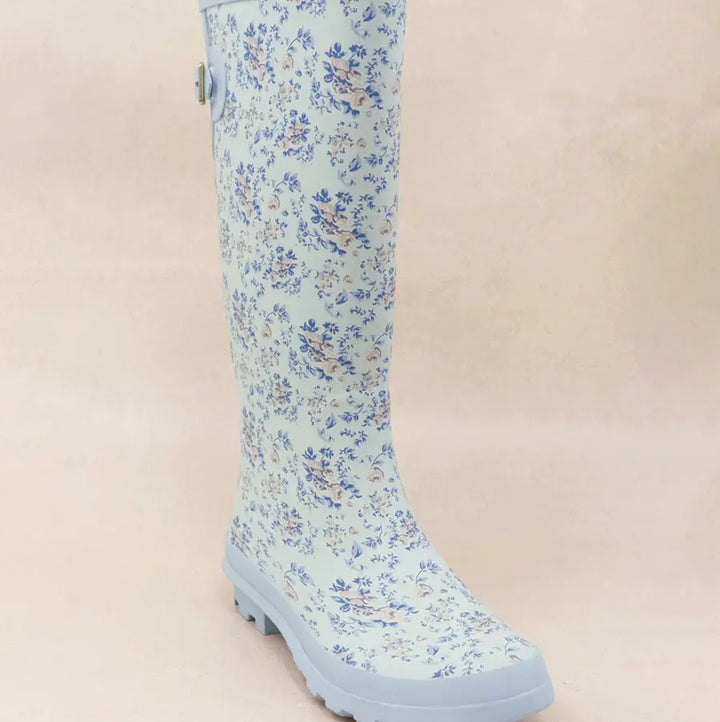 Blue floral patterned rain boots with textured sole for traction.