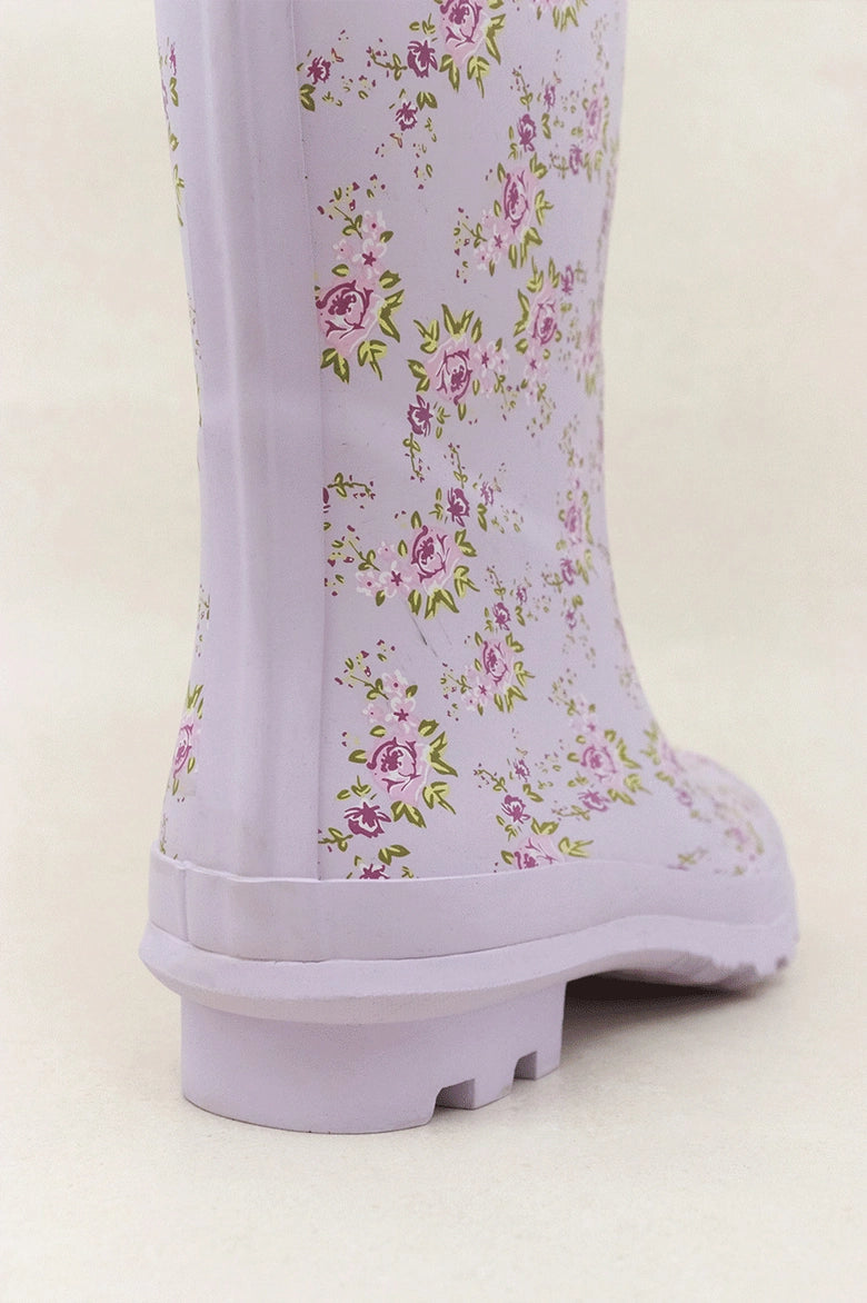 Lavender rain boots with a delicate floral print, providing both functionality and feminine style.