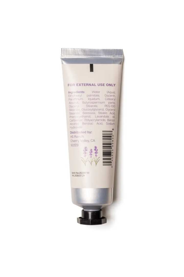 A white tube of Flower Market 1 oz hand cream with a label featuring lavender illustrations and product details.