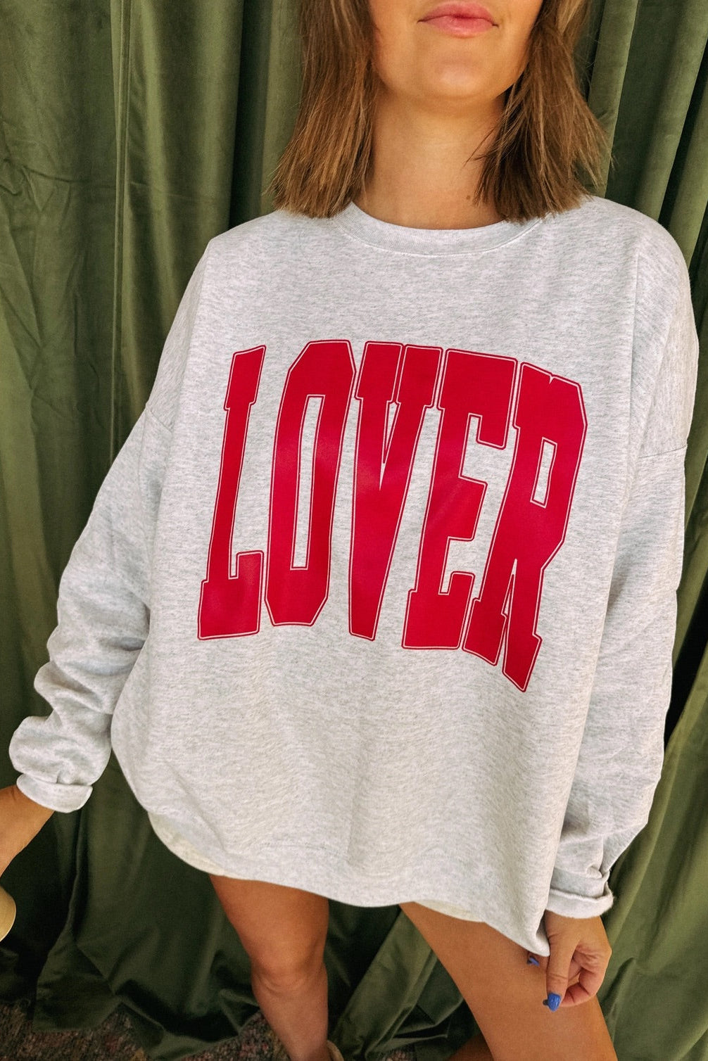 Gray crewneck sweatshirt with large red "LOVER" text printed on the front.