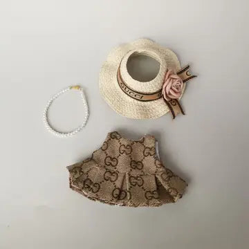 A straw hat with a rose, a beaded bracelet, and a patterned dress with pleated details, embodying a retro, elegant style.