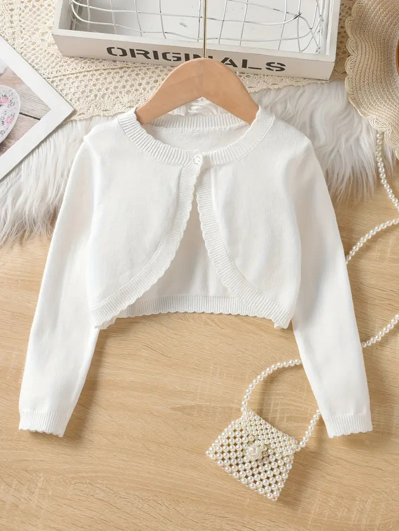 White children's knit cardigan with ruffled neckline and diamond-shaped pearl accent purse.