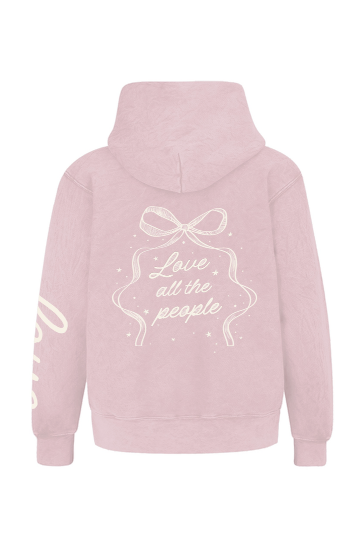 Light pink hooded sweatshirt with white bow graphic and text "Love all the people".