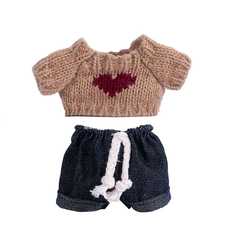 Knitted tan sweater with heart pattern, paired with navy blue denim shorts with rope drawstring.