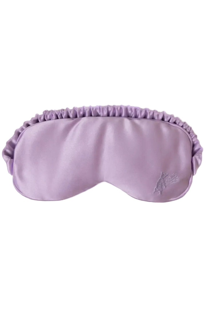 Lavender-colored eye mask made of soft satin with detachable pouch filled with cassia seeds and dried lavender flowers.