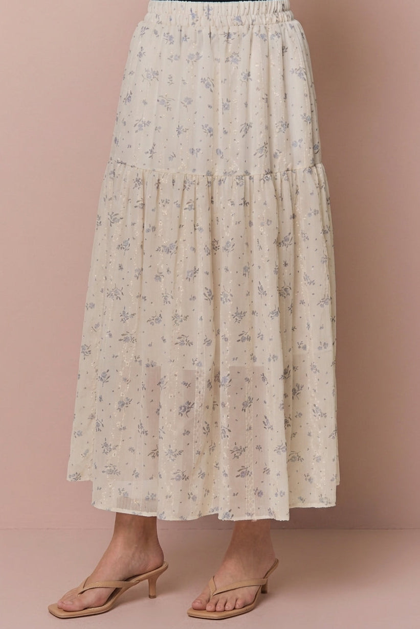 Cream floral tiered midi skirt with delicate embroidered details, modeled with tan heeled sandals.