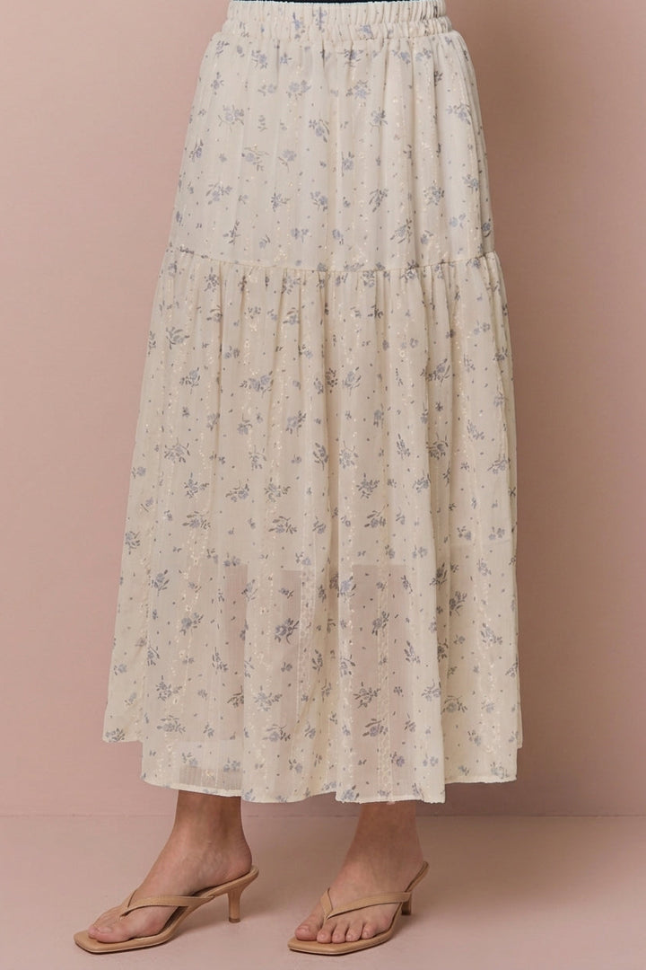 Cream floral tiered midi skirt with delicate embroidered details, modeled with tan heeled sandals.